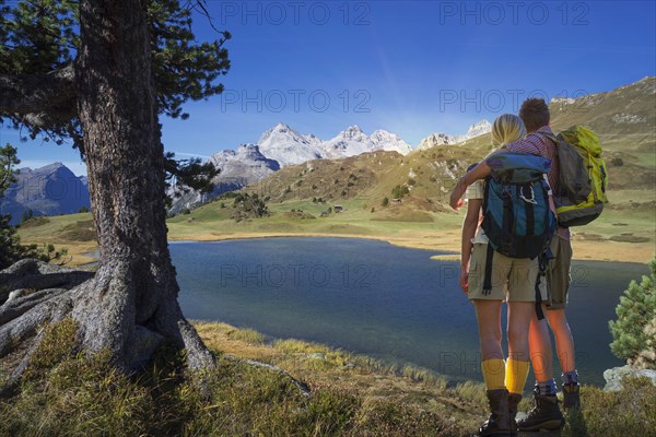 Caucasian hikers admiring remote lake