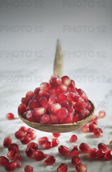 Close up of pomegranate seeds in spoon