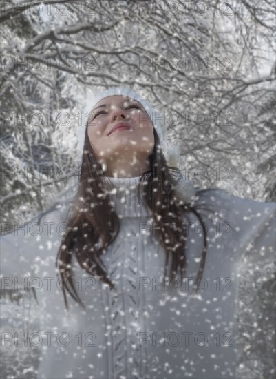 Caucasian woman playing in snow