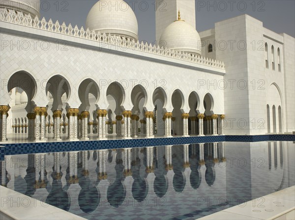 Ornate colonnade reflecting in still pool