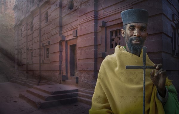 Black priest carrying cross in Lalibela