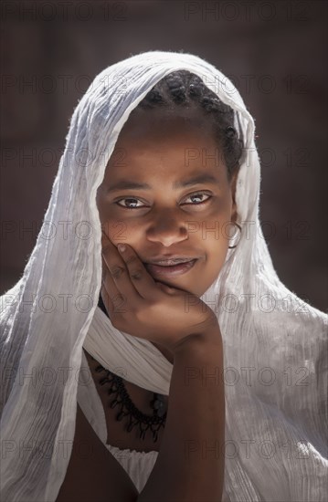 Smiling Black girl wearing headscarf