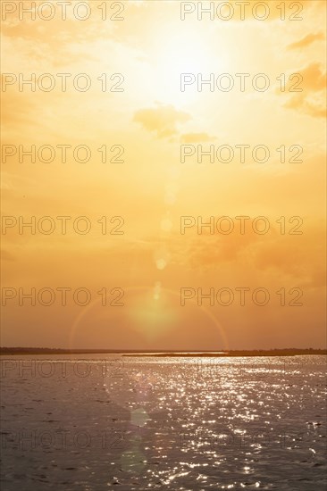 Sunset over rippling ocean water