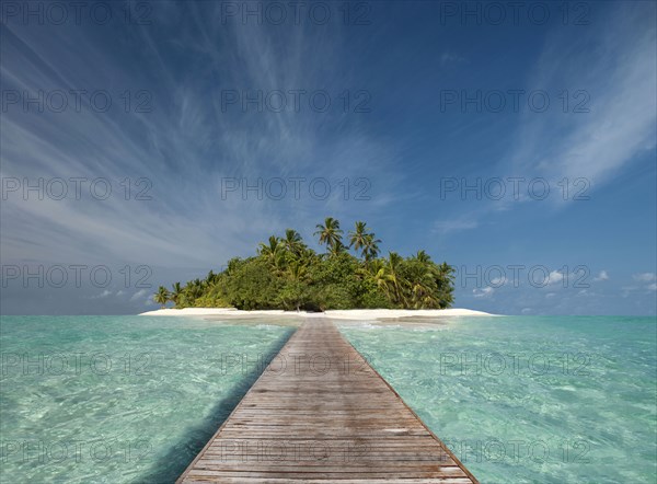 Wooden dock walkway to tropical island