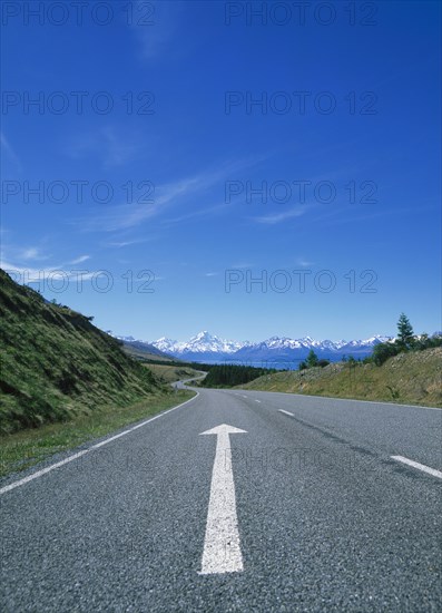 Directional arrow on empty remote road