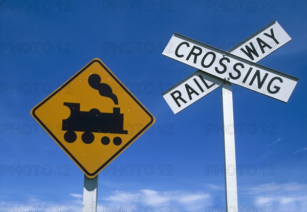 Low angle view of railway crossing signs