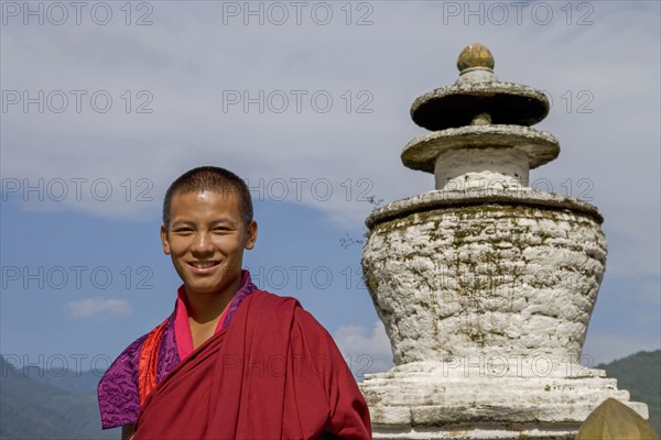 Asian boy smiling near statue