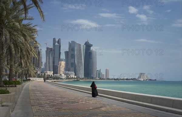 Woman walking on Doha waterfront