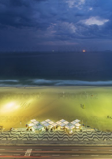 Aerial view of market on beach under cloudy sky