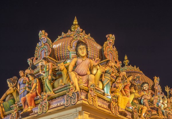 Low angle view of statues on ornate temple dome