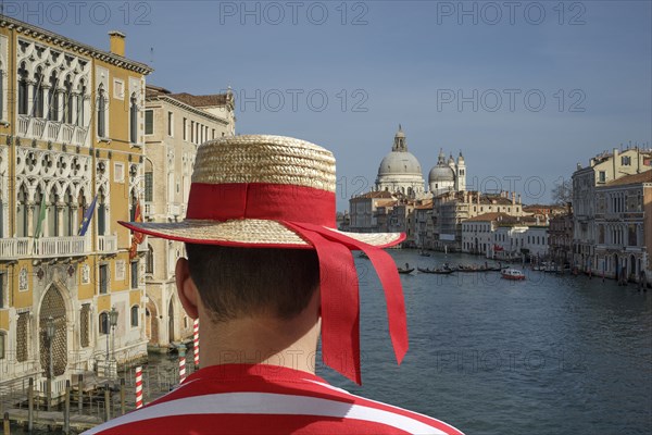 Caucasian gondolier admiring Venice cityscape