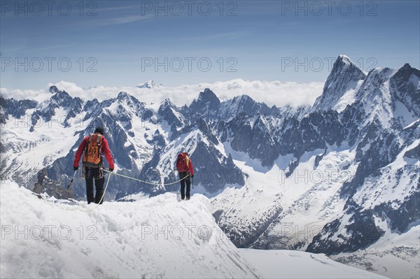 Caucasian skiers walking on mountaintop