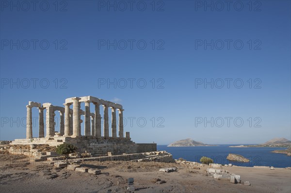 Temple of Poseidon ruins under blue sky