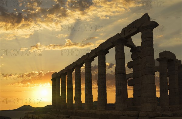 Temple of Poseidon ruins under sunset sky