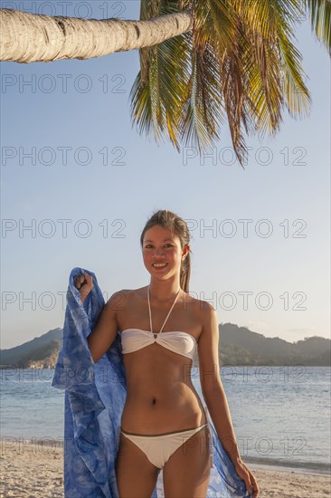Asian woman wearing bikini on beach