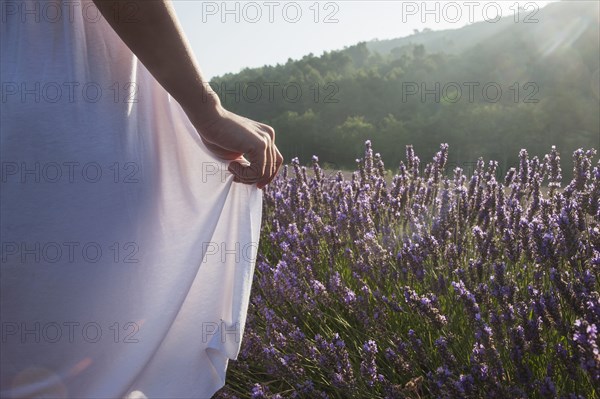 Caucasian woman walking in field of flowers
