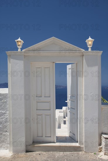 Door on hilltop over seascape