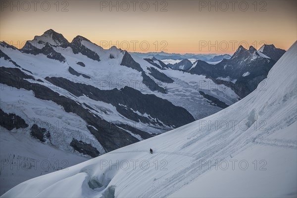 Hiker on snowy mountain slopes