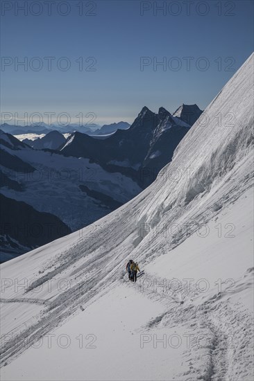 Hiker on snowy mountain slopes