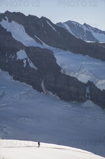 Hiker on snowy mountain slopes