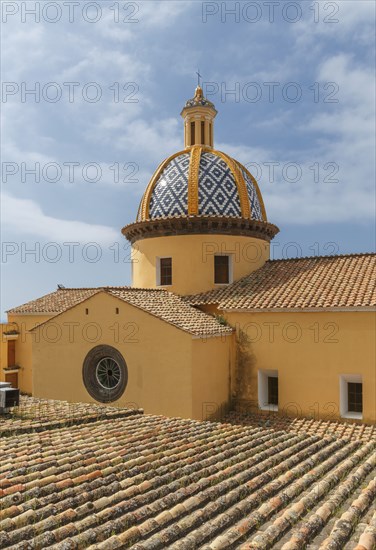 Church dome and roof under cloudy sky
