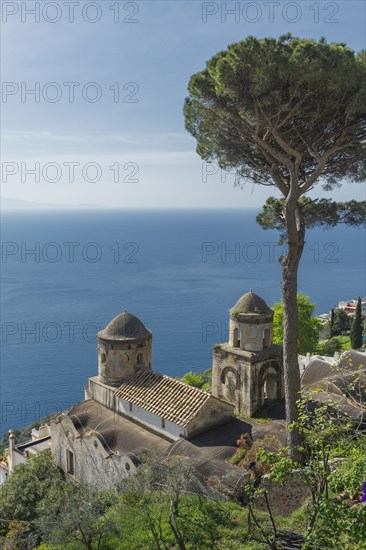 High angle view of church on hillside overlooking seascape