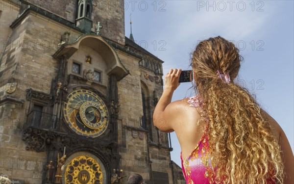 Caucasian woman photographing ornate church