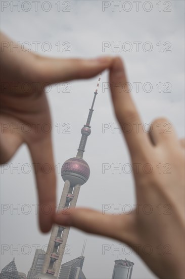 Chinese woman framing Shanghai tower