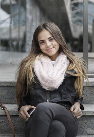 Caucasian woman sitting on steps