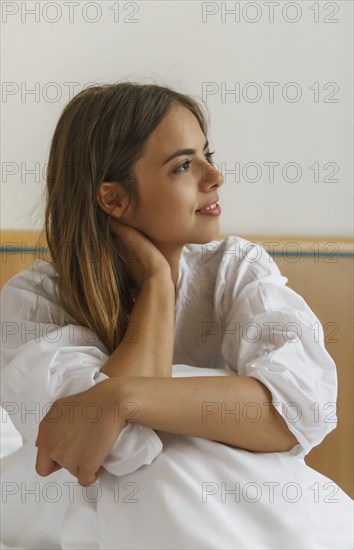 Caucasian woman sitting on bed