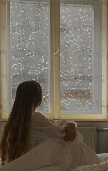 Caucasian woman looking out window