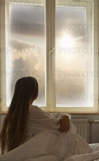 Caucasian woman looking out window