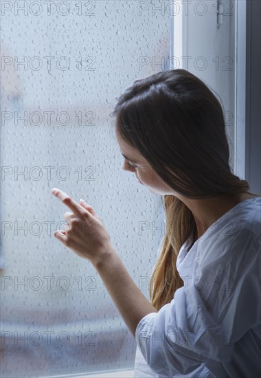 Caucasian woman looking out window