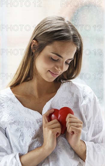 Caucasian woman holding heart