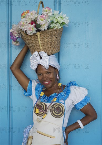 Black woman balancing basket on her head