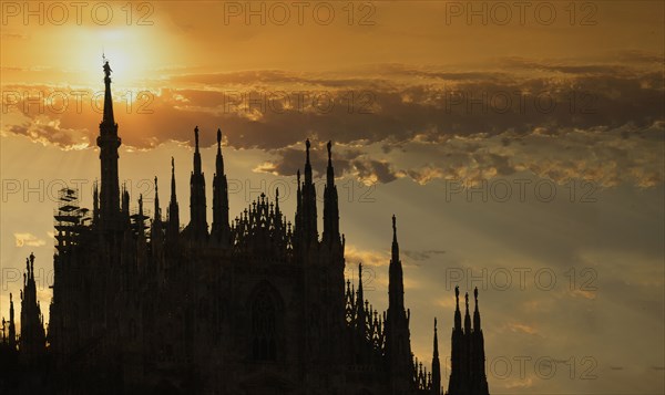 Silhouette of church under sunset sky