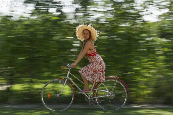 Caucasian woman riding bicycle