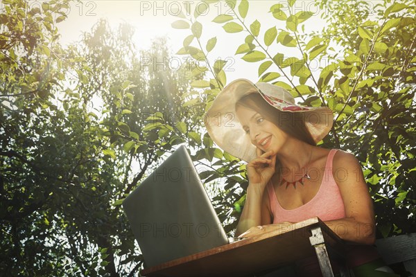 Caucasian woman using laptop outdoors