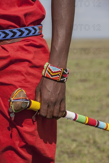 Black man with traditional bracelet and cane