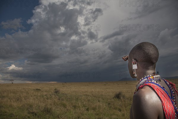 Black man in traditional clothing admiring view