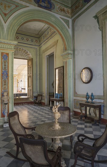 Table and chairs in ornate room