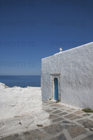 Cross on traditional building under blue sky