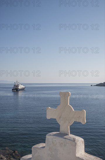 Cross on traditional arch and seascape