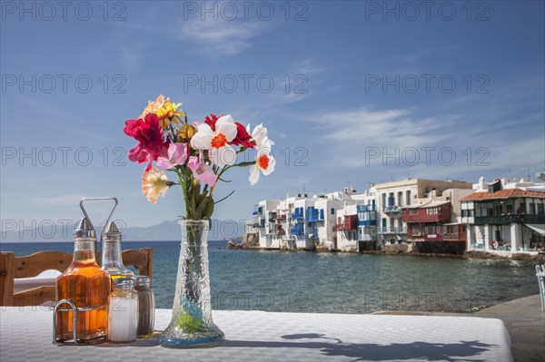 Seasonings and flowers on oceanfront cafe table