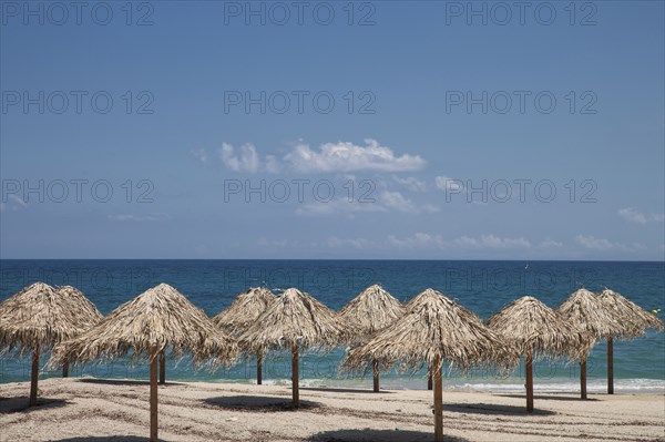 Thatch umbrellas on beach