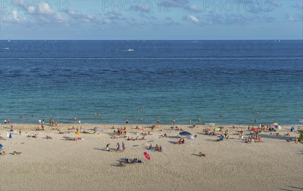 Tourists sunbathing on beach