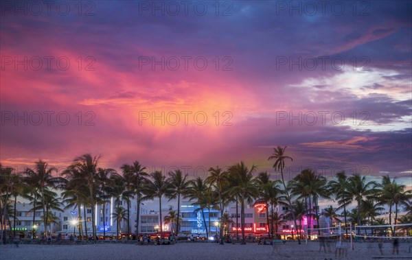 Beachfront buildings under sunset sky