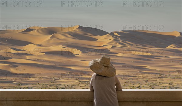 Caucasian woman admiring sand dunes in desert landscape