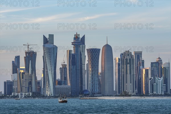 Boat floating near Doha skyline