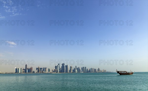 Boat floating near Doha skyline